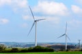 Wind Turbines and Blue Sky with Clouds over UK fields Royalty Free Stock Photo