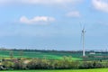 Wind Turbines and Blue Sky with Clouds over UK fields Royalty Free Stock Photo