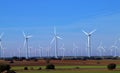 Wind turbines between crop fields in February.