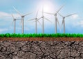 Wind turbines on green grass and dry soil cross section Royalty Free Stock Photo