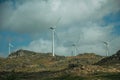 Wind turbines for electric power generation over hills Royalty Free Stock Photo