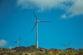 Wind turbines for electric power generation over hills Royalty Free Stock Photo