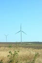 Wind turbines energy converters on the nature background