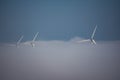 Wind turbines engulfed in fog bank Royalty Free Stock Photo