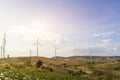 Wind turbines farm on mountanis landscape against blue sky with clouds background,Windmills for electric power ecology concept Royalty Free Stock Photo