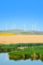 Wind turbines farm on a rural background