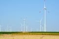 Wind turbines farm on a rural background