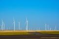 Wind turbines farm on a rural background