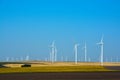 Wind turbines farm on a rural background
