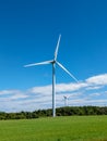 Wind Turbines in Field Against Blue Sky Royalty Free Stock Photo