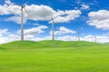 Wind turbines in a field of green grass Royalty Free Stock Photo