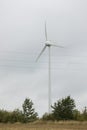 Wind turbines field in a stormy day with strong wind and rain. Wind farm eco field. Green ecological power