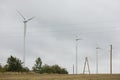 Wind turbines field in a stormy day with strong wind and rain. Wind farm eco field. Green ecological power Royalty Free Stock Photo