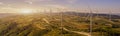 Wind turbines in a field, wind turbine farm sundown, Wind Power Turbines in a rural area, Tracking shot of energy producing wind