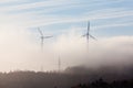 Wind turbines in fog Royalty Free Stock Photo