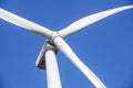 Wind turbines generating electricity with blue sky. Close up of Wind turbine producing alternative energy Royalty Free Stock Photo