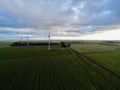 wind turbines generating on a green field with an ominous sky overhead Royalty Free Stock Photo