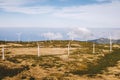 Wind turbines for green energy in a windy place high in the mountains above the clouds. Royalty Free Stock Photo