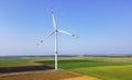 Wind turbines among a green field on a sunny autumn day Royalty Free Stock Photo