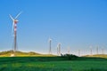 Wind turbines on green grass Royalty Free Stock Photo