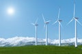 Wind turbines on a green grass field against blue sky background Royalty Free Stock Photo