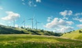 Wind turbines on a green hill with blue sky