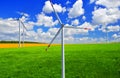 Wind turbines on a green wheat field in Ukraine
