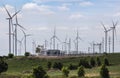 Wind turbines with high voltage electrical power pylon substation for renewable wind energy Royalty Free Stock Photo