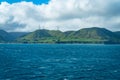 Wind turbines on hill from blustery Cook Strait Wellington southern coastline