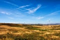 Wind turbines on hilly expanse create energy