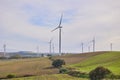 Wind turbines with landscape of agricultural fields under blue sky Royalty Free Stock Photo
