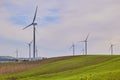 Wind turbines with landscape of agricultural fields under blue sky Royalty Free Stock Photo