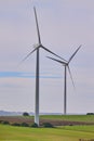 Wind turbines with landscape of agricultural fields under blue sky Royalty Free Stock Photo