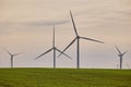 Wind turbines with landscape of agricultural fields under blue sky Royalty Free Stock Photo