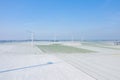 Wind turbines in the middle of a snowy field in Europe, France, Normandy, between Dieppe and Fecamp, in Winter, on a sunny day Royalty Free Stock Photo