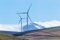 Wind turbines with mountains and clouds in the background Royalty Free Stock Photo