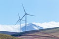 Wind turbines with mountains and clouds in the background Royalty Free Stock Photo