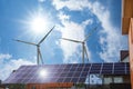 Wind turbines near house with solar panels on roof. Alternative energy source Royalty Free Stock Photo