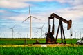 Wind turbines and oil rigs with large oil pump in West Texas creating large amounts of energy