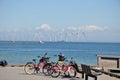 Wind turbines park and cargo ship passes in international water Royalty Free Stock Photo