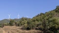 Wind turbines in the plain in the hills. Royalty Free Stock Photo