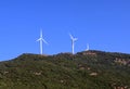 Wind turbines in the plain in the hills. Royalty Free Stock Photo