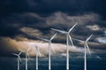 Wind turbines power generators on a stormy dramatic sky Renewable and sustainable energy concept Royalty Free Stock Photo