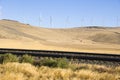 Wind turbines and railroad tracks. Royalty Free Stock Photo