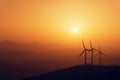 Wind turbines silhouette on mountain at sunset