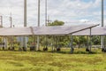 Wind turbines with solar panels farm on mountanis landscape against blue sky with clouds background Royalty Free Stock Photo