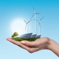 Wind turbines and solar panels in female hand Royalty Free Stock Photo