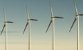 Wind turbines spinning to generate electricity for households on sea with dawn sky as renewable power plant. clean and sustainable