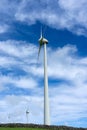 Wind turbines stand tall against a cloudy sky on Terceira Island, Azores. Royalty Free Stock Photo