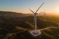 Wind turbines at sunrise. Wind farm generating green power